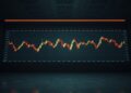 Dim trading floor with faint candlestick charts symbolizing falling crypto exchange volume