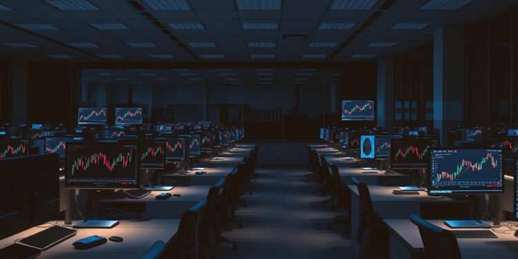 Empty crypto exchange office desks with market chart monitors representing Coinbase restructuring